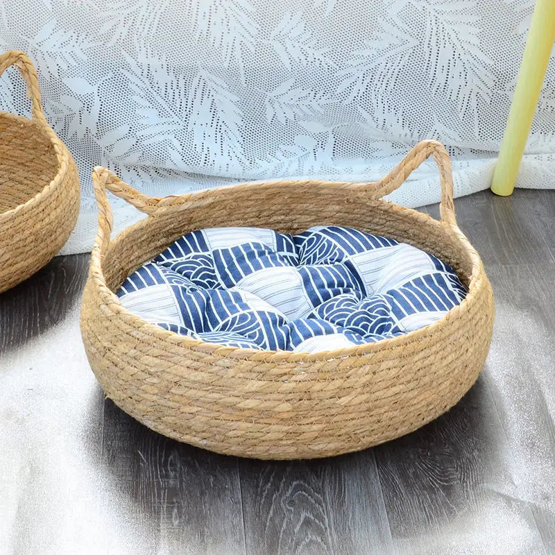 Woven basket with a cream-colored cushion on a white background